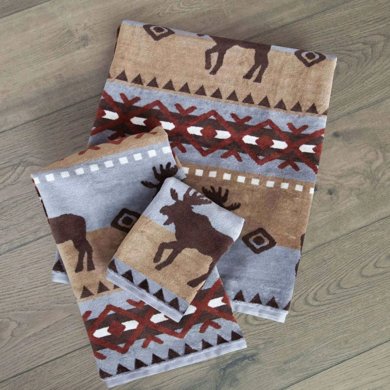 Set of reindeer-themed knit scarves in neutral tones with festive patterns.