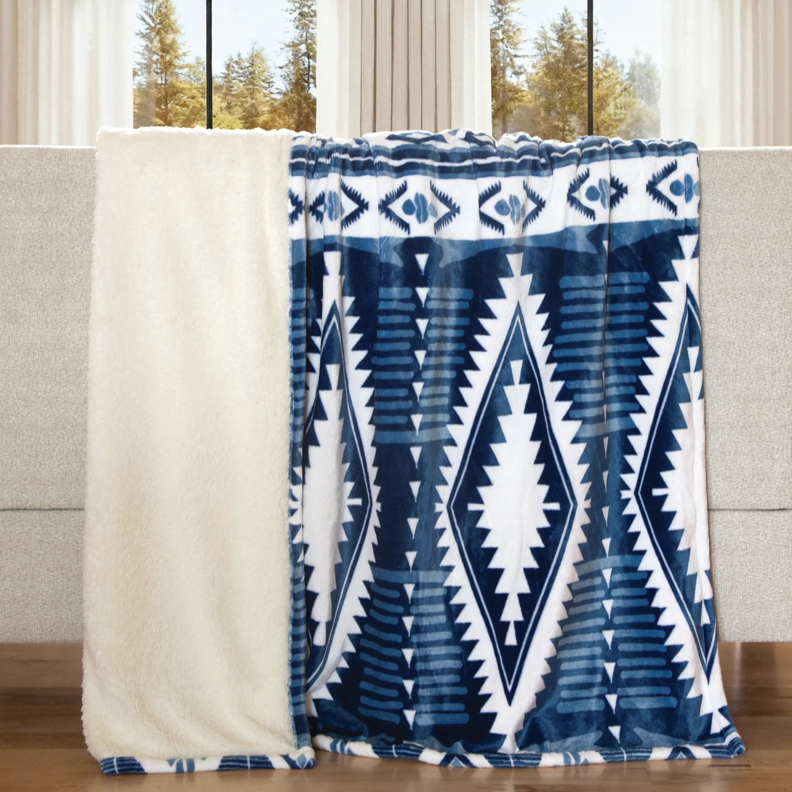 Blue and white patterned blanket on sofa.